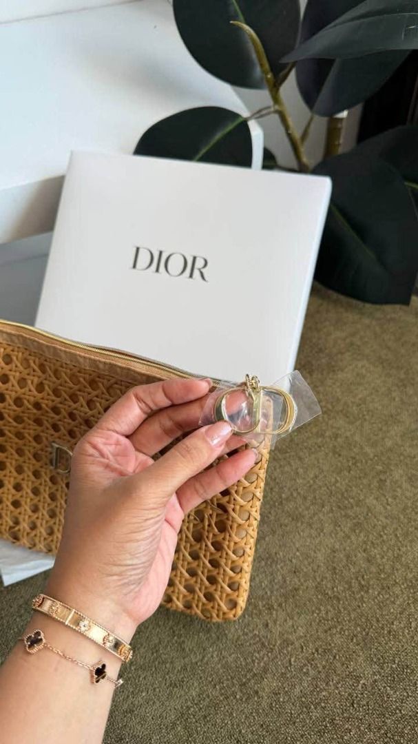 Christian Dior Woven Pouch Bag with Box (Category: Purses & Pouches) located in Manila. Submitted by liahsells (Listing ID 1467036839, Image 2). Description: - Authentic Christian Dior woven straw bag in a chic tan shade - Features sleek gold zipper closure and iconic CD charms (still wrapped in original plastic) - Soft, slouchy silhouette with a spacious interior for daily essentials or evening outings - Clean interior lining - Includes original
