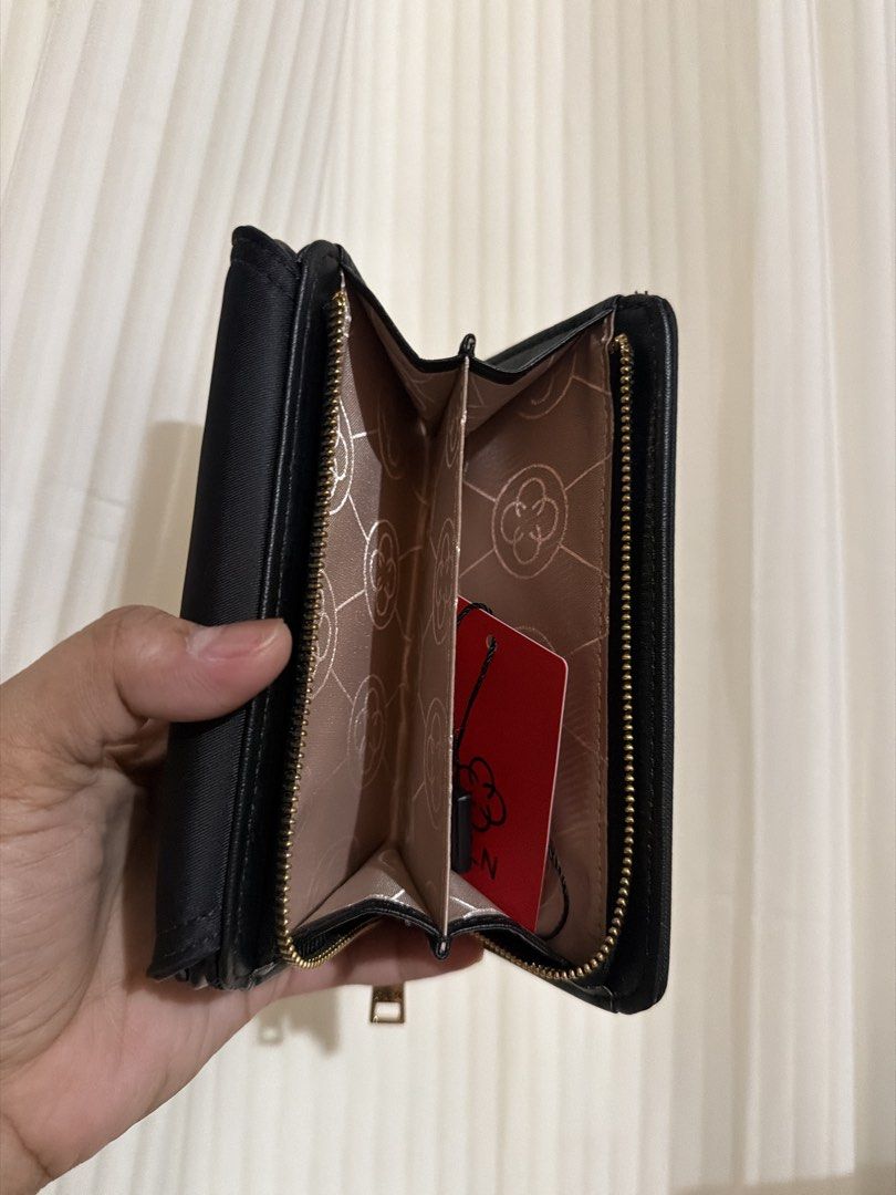 CLN Black Wallet with Gold Logo (Category: Wallets & Card holders) located in San Juan City. Submitted by thisismeely (Listing ID 1467168056, Image 3). Description: - Brand: CLN - Color: Black with gold-tone hardware and elegant lettering - Material: Durable fabric with stylish leather trim - Interior: Multiple card slots, clear ID window, and a secure zippered compartment - Condition: Brand new with tag still attached inside the coin pocket - Li