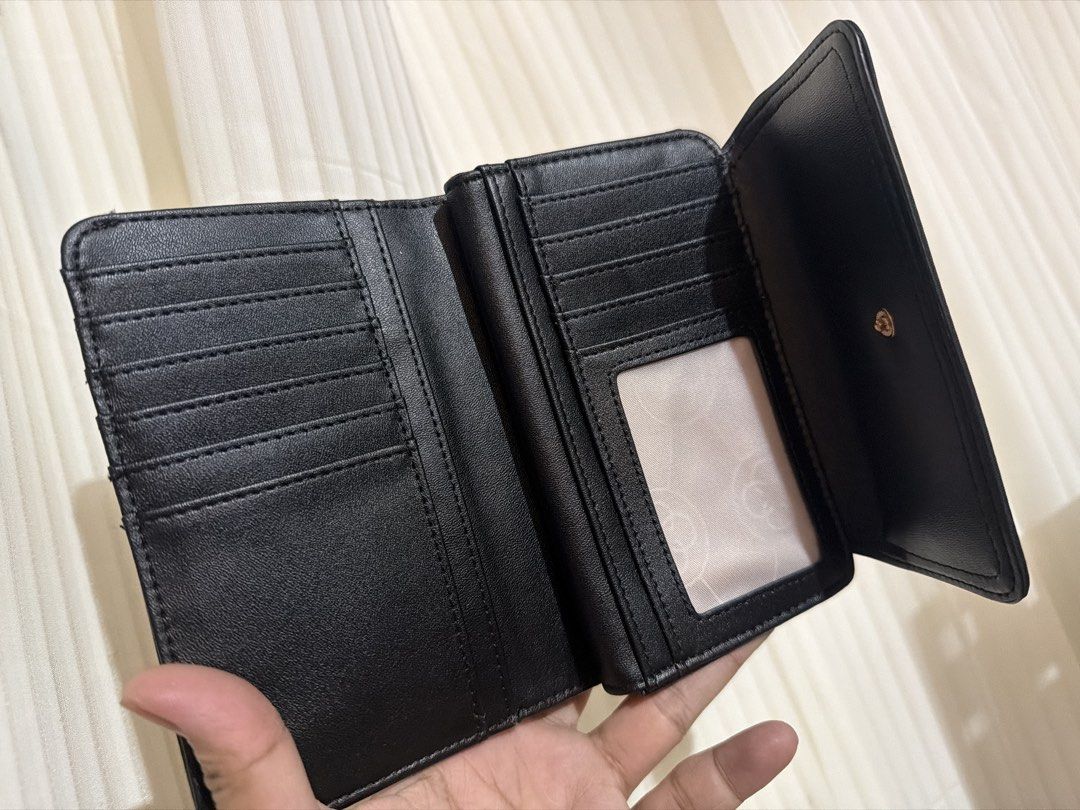 CLN Black Wallet with Gold Logo (Category: Wallets & Card holders) located in San Juan City. Submitted by thisismeely (Listing ID 1467168056, Image 2). Description: - Brand: CLN - Color: Black with gold-tone hardware and elegant lettering - Material: Durable fabric with stylish leather trim - Interior: Multiple card slots, clear ID window, and a secure zippered compartment - Condition: Brand new with tag still attached inside the coin pocket - Li