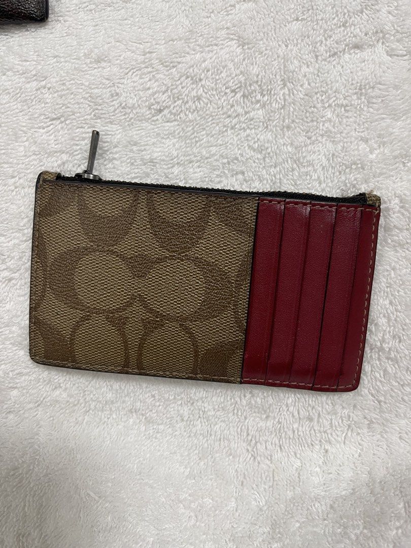 Coach and Lululemon Card Holder Wallets Assorted Collection (Category: Wallets & Card holders) located in Taguig. Submitted by 1307maloc (Listing ID 1467084335, Image 3). Description: - Set of 4 stylish card holder wallets - Includes 3 Coach designs: signature canvas, brown leather, and cream embossed leather - Includes 1 green Lululemon zippered pouch with orange trim and round logo zip pull - Multiple slots for cards, cash, and IDs - Secure zip