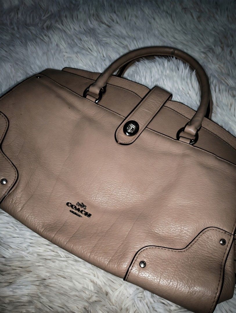 Coach Beige Leather Satchel Handbag (Category: Luxury Bags & Wallets) located in Manila. Submitted by littlenicsfinds (Listing ID 1467079107, Image 1). Description: - Authentic Coach leather satchel in versatile taupe beige - Double top handles with sleek silver-toned hardware - Secure front strap closure with signature turnlock detail - Structured silhouette with subtle contrast stitching - Spacious everyday carryall with an embossed Coach logo 