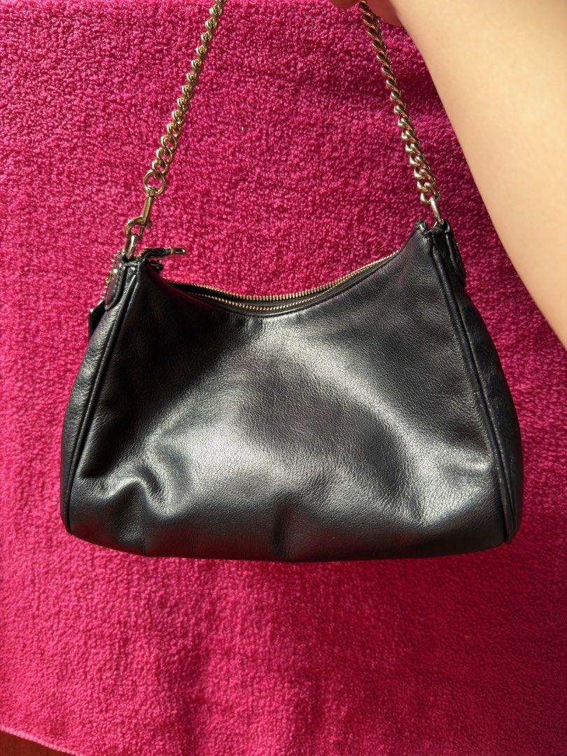 Coach Black Leather Shoulder Bag (Category: Luxury Bags & Wallets) located in Manila. Submitted by missviolet0298 (Listing ID 1467017351, Image 2). Description: - Brand: Coach New York - Material: Premium black pebbled leather - Hardware: Elegant gold-tone with metallic front logo stamping - Closure & Interior: Secure zip top closure with clean fabric lining - Extras: Includes a classy detachable chain strap and an adjustable/longer leather cross