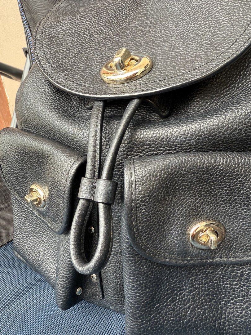 Coach Black Pebble Leather Turnlock Backpack (Category: Backpacks) located in Bacoor. Submitted by michiepeachy (Listing ID 1467003534, Image 2). Description: - Authentic Coach black pebble leather backpack - Gold-tone hardware - Front flap with turnlock and two handy front patch pockets - Secure drawstring main compartment closure - Signature Coach logo fabric lining inside with zip and slip pockets - Coach side exterior stamp and interior leath