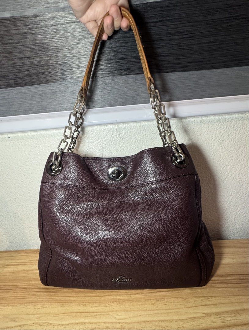 Coach Burgundy Leather Shoulder Bag with Chain Strap (Category: Luxury Bags & Wallets) located in Abucay. Submitted by miaou_finds (Listing ID 1467143236, Image 3). Description: ✨Guaranteed Authentic✨ Coach pebbled leather shoulder bag in rich dark burgundy. Features distinctive chain and leather strap combination, signature turnlock closure, and silver-tone hardware. Interior lined in fabric with zippered pocket and Coach leather creed patch sho