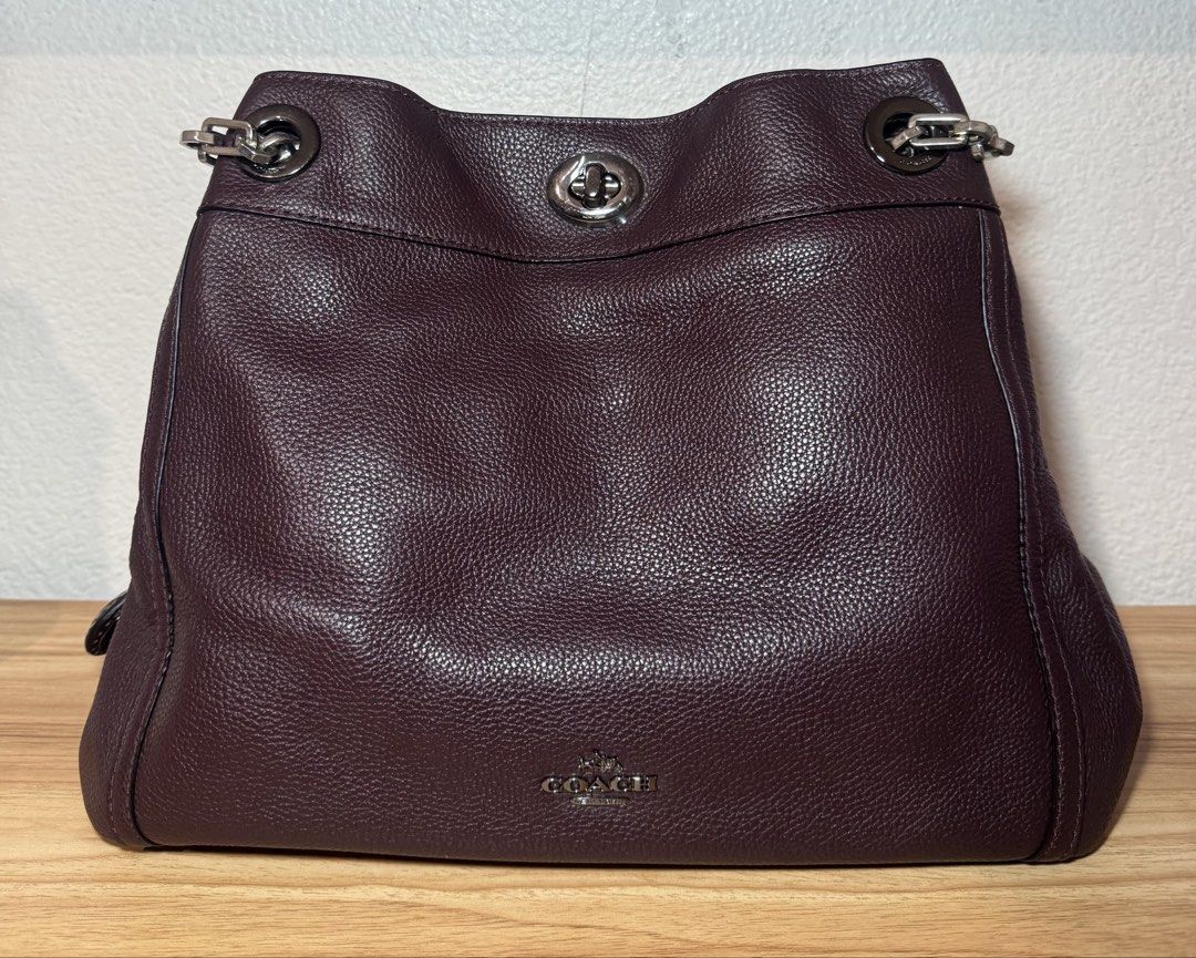 Coach Burgundy Leather Shoulder Bag with Chain Strap (Category: Luxury Bags & Wallets) located in Abucay. Submitted by miaou_finds (Listing ID 1467143236, Image 1). Description: ✨Guaranteed Authentic✨ Coach pebbled leather shoulder bag in rich dark burgundy. Features distinctive chain and leather strap combination, signature turnlock closure, and silver-tone hardware. Interior lined in fabric with zippered pocket and Coach leather creed patch sho