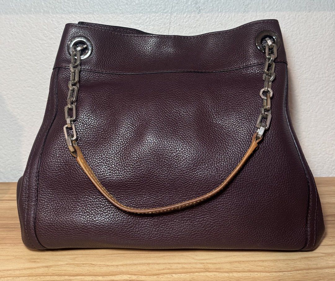 Coach Burgundy Leather Shoulder Bag with Chain Strap (Category: Luxury Bags & Wallets) located in Abucay. Submitted by miaou_finds (Listing ID 1467143236, Image 2). Description: ✨Guaranteed Authentic✨ Coach pebbled leather shoulder bag in rich dark burgundy. Features distinctive chain and leather strap combination, signature turnlock closure, and silver-tone hardware. Interior lined in fabric with zippered pocket and Coach leather creed patch sho