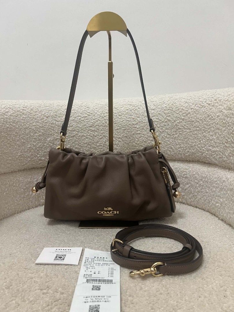 Coach Faye Shoulder Bag with Sling (Category: Shoulder Bags) located in Paoay. Submitted by rvf1230 (Listing ID 1467036081, Image 2). Description: Coach shoulder bag in rich brown leather. Gathered ruching detail along the top. Gold-tone hardware and Coach logo on the front. Includes main shoulder strap plus an extra adjustable crossbody strap. Inside features fabric lining, zippered pocket, and magnetic snap closure. Original store tags and rece