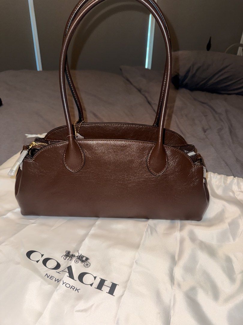 Coach Glzd Empire 34 B4/Maple Handbag (Category: Luxury Bags & Wallets) located in Pasay City. Submitted by ccpetitte (Listing ID 1466971442, Image 2). Description: - Brand: Coach - Model: Glzd Empire 34 - Color: B4/Maple (Brown leather) - Condition: Brand new with original store tag and dust bag - Hardware: Gold-tone (protective wrapping still on parts) - Features: Double top handles, secure top zip closure.