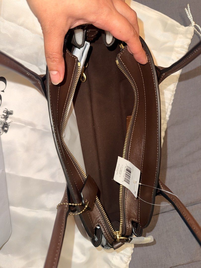 Coach Glzd Empire 34 B4/Maple Handbag (Category: Luxury Bags & Wallets) located in Pasay City. Submitted by ccpetitte (Listing ID 1466971442, Image 3). Description: - Brand: Coach - Model: Glzd Empire 34 - Color: B4/Maple (Brown leather) - Condition: Brand new with original store tag and dust bag - Hardware: Gold-tone (protective wrapping still on parts) - Features: Double top handles, secure top zip closure.