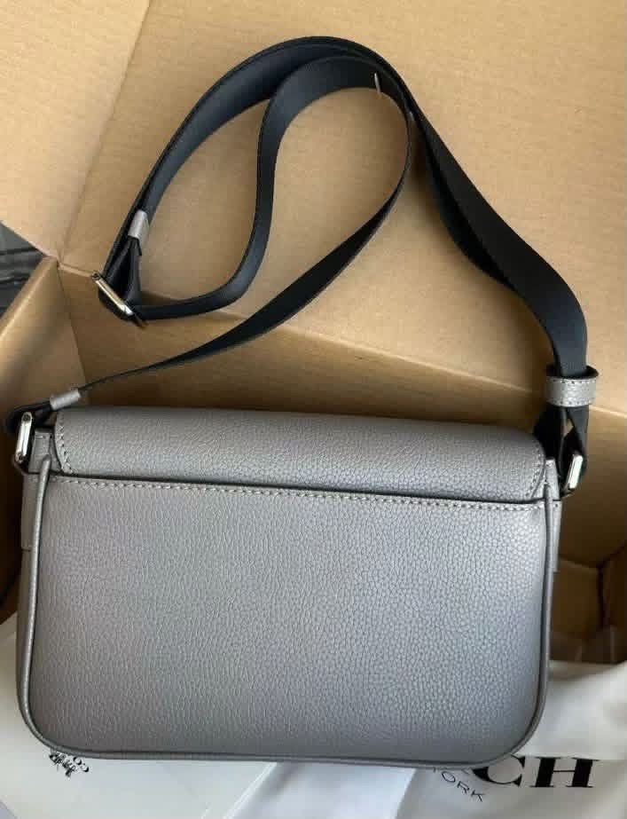 Coach Grey Leather Crossbody Bag (Category: Sling Bags) located in Manila. Submitted by bagsandmanymanymore1 (Listing ID 1466986863, Image 3). Description: - Authentic Coach crossbody bag in grey pebbled leather - Adjustable black fabric strap for comfortable wear - Secure magnetic snap closure with front flap and embossed Coach logo - Silver-tone hardware and neat contrast stitching - Soft suede-lined interior with convenient slip pockets and le