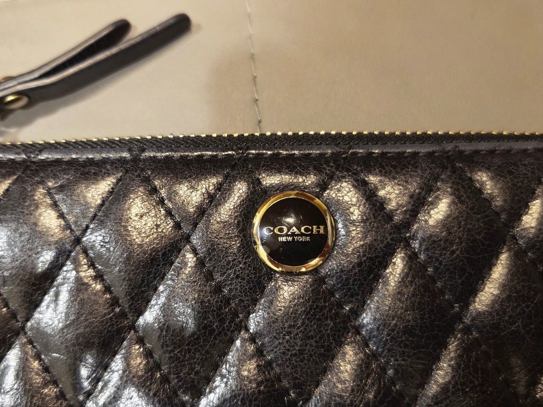 Coach Quilted Black Leather Zip Around Wallet (Category: Wallets & Card holders) located in Baguio. Submitted by zia_zab (Listing ID 1467103547, Image 3). Description: - Brand: Coach - Color: Classic Black - Material: Premium quilted leather with chic diamond stitching - Hardware: Elegant gold-toned logo plaque and sturdy zippers - Closure: Secure zip-around with a matching leather pull tab - Interior: Smooth black leather lining - Design: Compac
