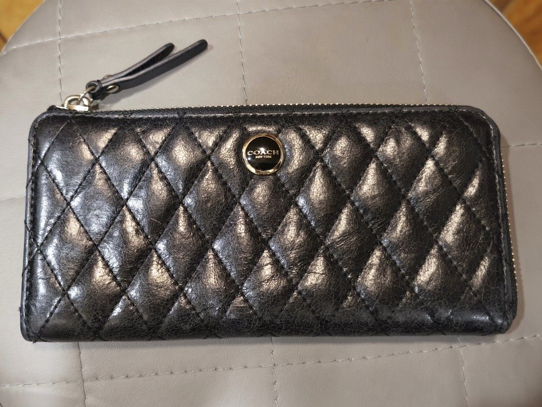 Coach Quilted Black Leather Zip Around Wallet (Category: Wallets & Card holders) located in Baguio. Submitted by zia_zab (Listing ID 1467103547, Image 1). Description: - Brand: Coach - Color: Classic Black - Material: Premium quilted leather with chic diamond stitching - Hardware: Elegant gold-toned logo plaque and sturdy zippers - Closure: Secure zip-around with a matching leather pull tab - Interior: Smooth black leather lining - Design: Compac