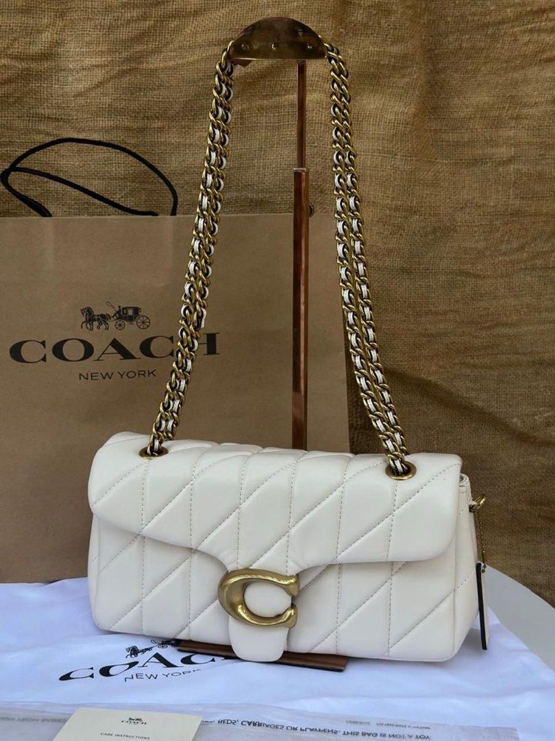 Coach Quilted Pillow Tabby Shoulder Bag White (Category: Clutches) located in Manila. Submitted by mimi4373 (Listing ID 1467113787, Image 1). Description: - Auth CH quilted - Complete set: original dust bag, paper bag, and auth card/receipt booklet.
