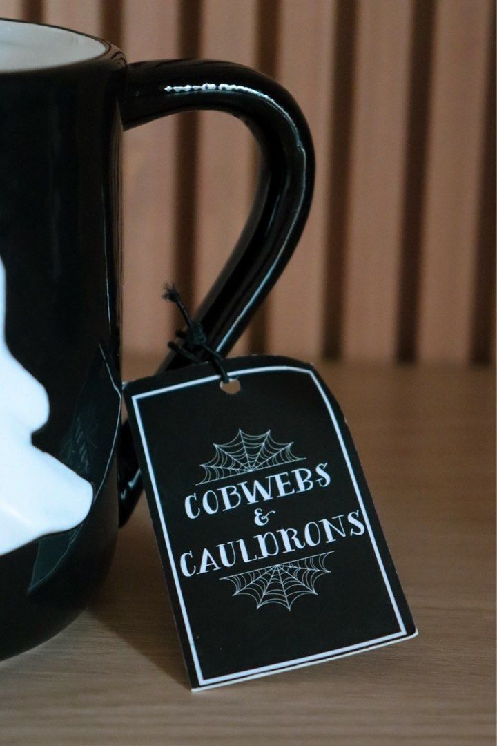 Cobwebs & Cauldrons Ghost & Dog Hand-Painted Mug (Category: Coffee & Tea Tableware) located in Marikina City. Submitted by hellolei_c (Listing ID 1467034125, Image 3). Description: • Cobwebs & Cauldrons • 3D Embossed Ghost & Ghost Dog with gold stars and crescent moon • Hand-painted glossy ceramic • 100% Brand New with original hanging store tag & sticker Great as a Halloween gift, desk decor, or daily coffee mug 👻 .
