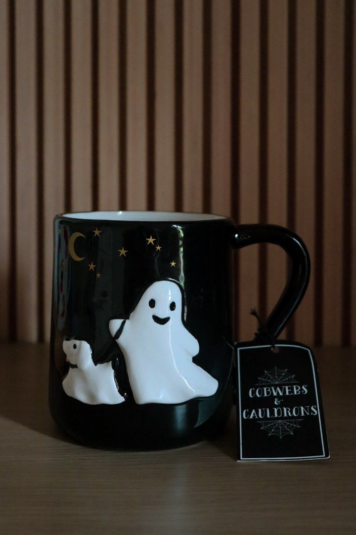 Cobwebs & Cauldrons Ghost & Dog Hand-Painted Mug (Category: Coffee & Tea Tableware) located in Marikina City. Submitted by hellolei_c (Listing ID 1467034125, Image 1). Description: • Cobwebs & Cauldrons • 3D Embossed Ghost & Ghost Dog with gold stars and crescent moon • Hand-painted glossy ceramic • 100% Brand New with original hanging store tag & sticker Great as a Halloween gift, desk decor, or daily coffee mug 👻 .