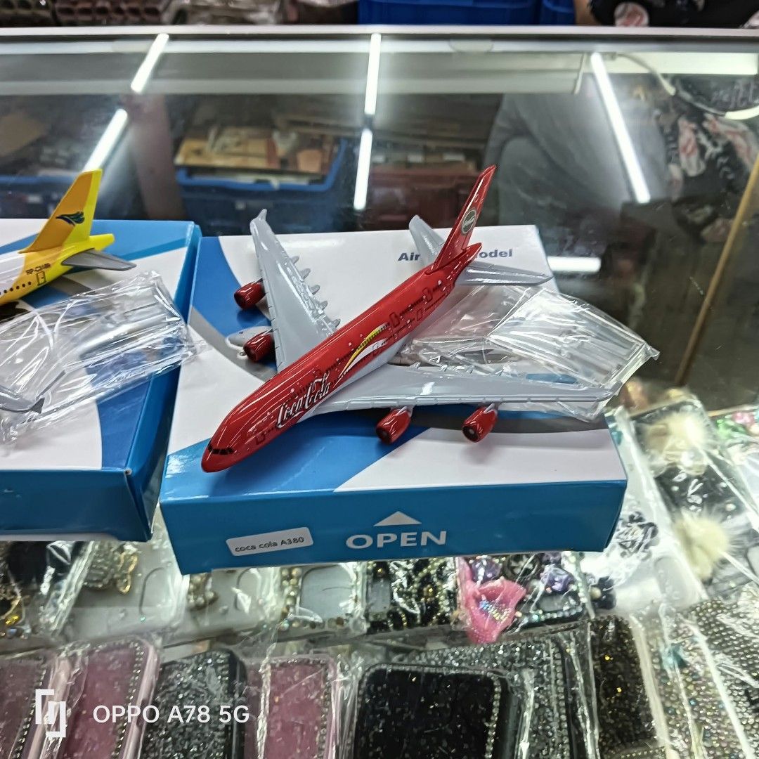 Coca-Cola A380 Diecast Airplane Model Toy (Category: Vehicle & Diecast Models) located in Manila. Submitted by iliasjen3082126 (Listing ID 1467065037, Image 1). Description: - Authentic Coca-Cola A380 diecast airplane model - Iconic red body with white wings and classic fuselage branding - Includes original blue and white collector's box - Comes with separately wrapped plastic stands and parts - Perfect for aviation enthusiasts and Coca-Cola coll