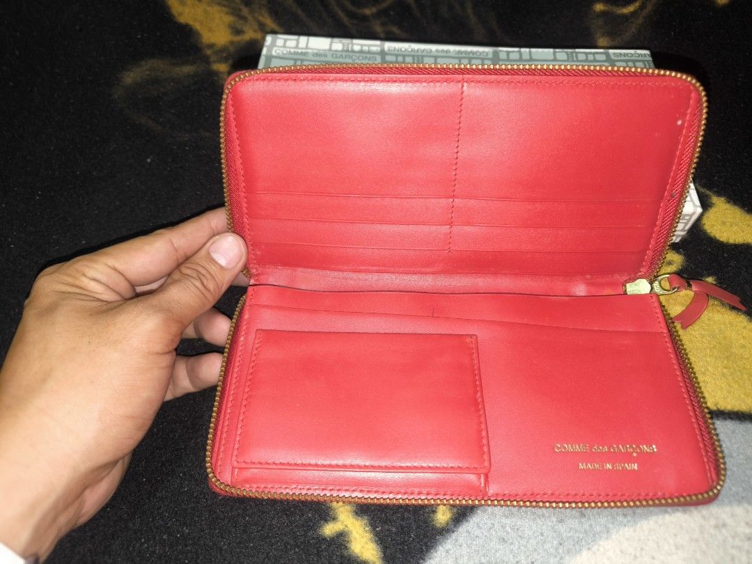 COMME des GARÇONS Red Polka Dot Zip Wallet (Category: Wallets & Card holders) located in Manila. Submitted by fljaoti27 (Listing ID 1467008657, Image 3). Description: - Authentic red leather long wallet made in Spain - Cute white polka dot print all over with gold-tone hardware - Secure zip-around closure keeps your essentials safe - Organized interior with multiple card slots, slip compartments, and a snap coin pouch - Features a chic gold foil 
