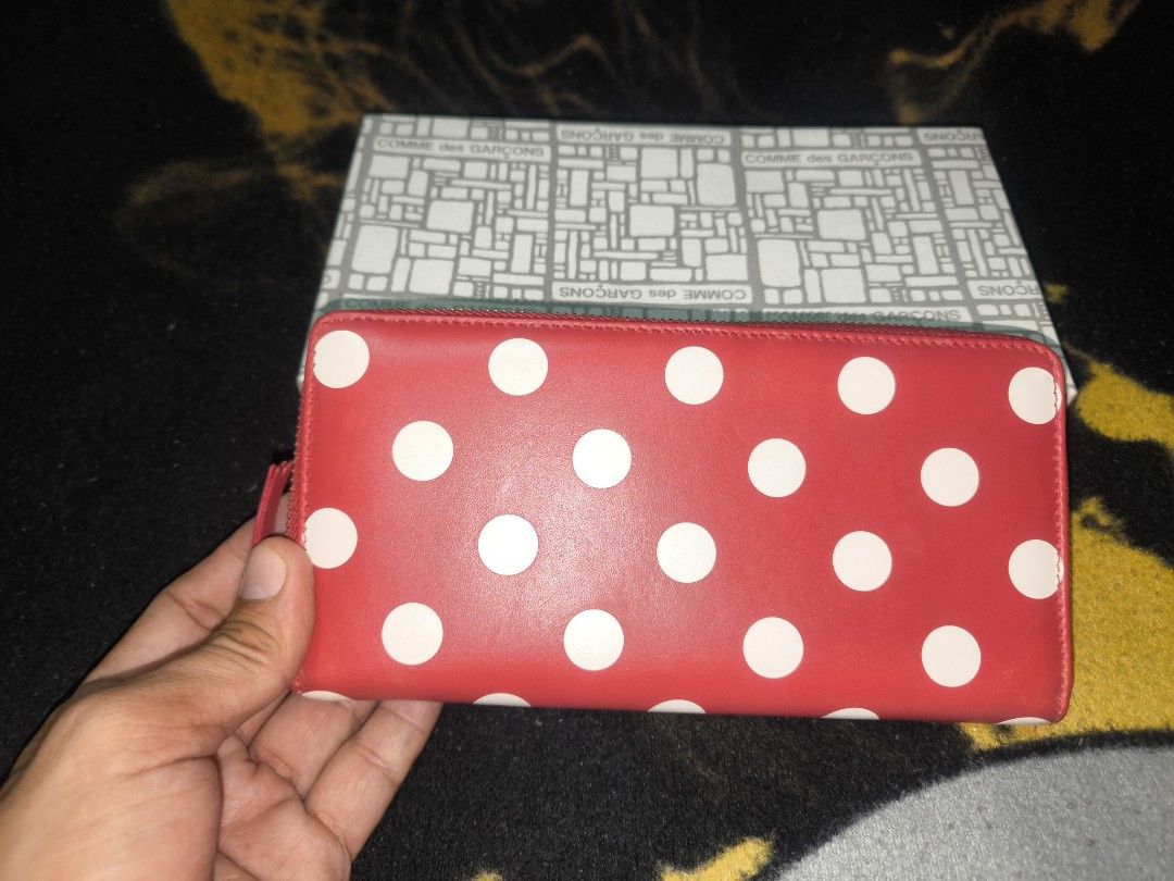 COMME des GARÇONS Red Polka Dot Zip Wallet (Category: Wallets & Card holders) located in Manila. Submitted by fljaoti27 (Listing ID 1467008657, Image 2). Description: - Authentic red leather long wallet made in Spain - Cute white polka dot print all over with gold-tone hardware - Secure zip-around closure keeps your essentials safe - Organized interior with multiple card slots, slip compartments, and a snap coin pouch - Features a chic gold foil 