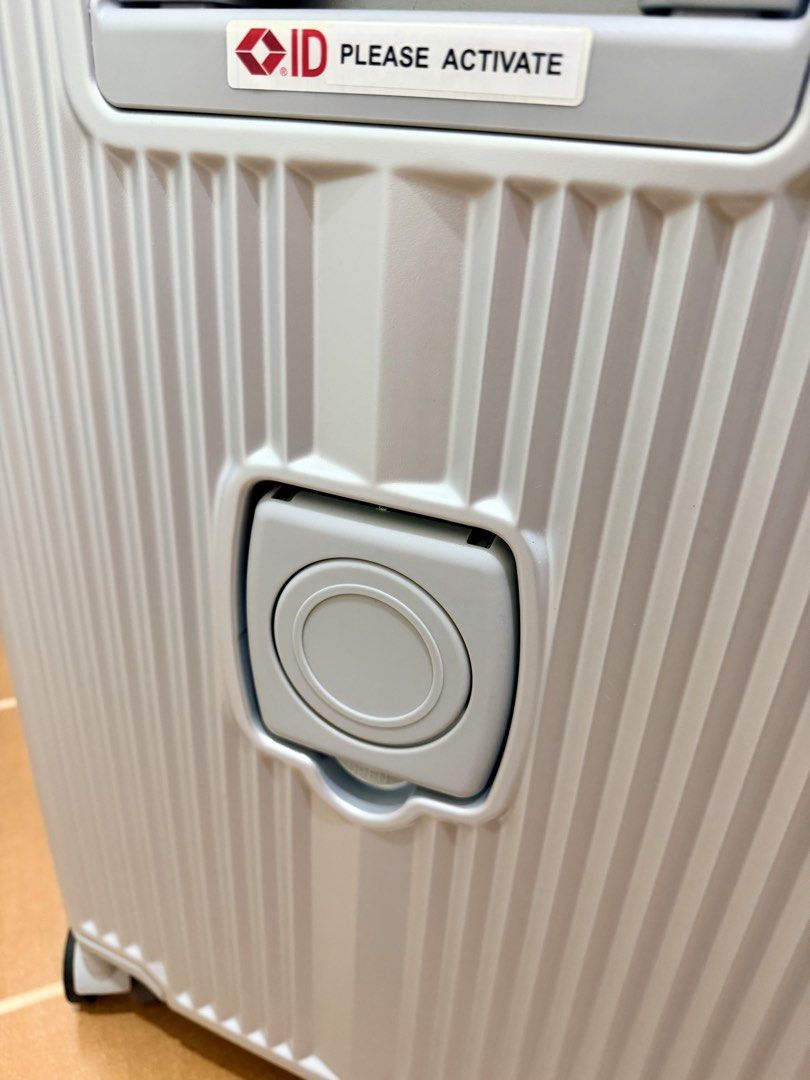 Compass Luggage Silver Hard Case Suitcase TSA Lock (Category: Luggage) located in Mandaluyong City. Submitted by miss_a18 (Listing ID 1467105296, Image 2). Description: Silver Compass hardshell luggage with vertical ribbed texture. Integrated TSA-approved combination lock on top. Sturdy aluminum frame closure with multiple metal hinges down the side. Dual wheels on all four corners for smooth rolling. Grey fabric interior lining includes zippered