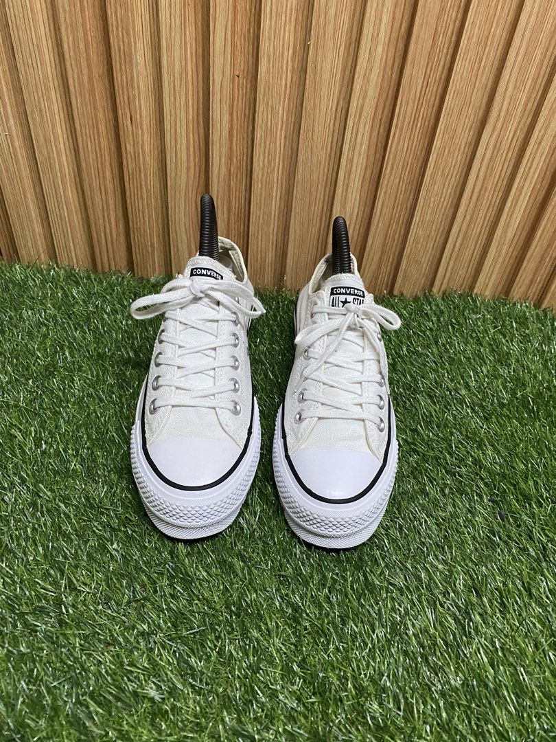 Converse All Star Platform White Sneakers (Category: Sneakers) located in Butuan. Submitted by chang_14 (Listing ID 1467071656, Image 2). Description: - Brand: Converse - Style: Low-top platform sneakers - Color: Classic white with black midsole stripes - Size: Women's US 6 / UK 4 / EUR 36.5 / CM 23 - Material: Canvas upper, brown rubber outsole with diamond tread - Details: Silver-tone eyelets, white toe cap, All Star heel patch - Condition: Cle