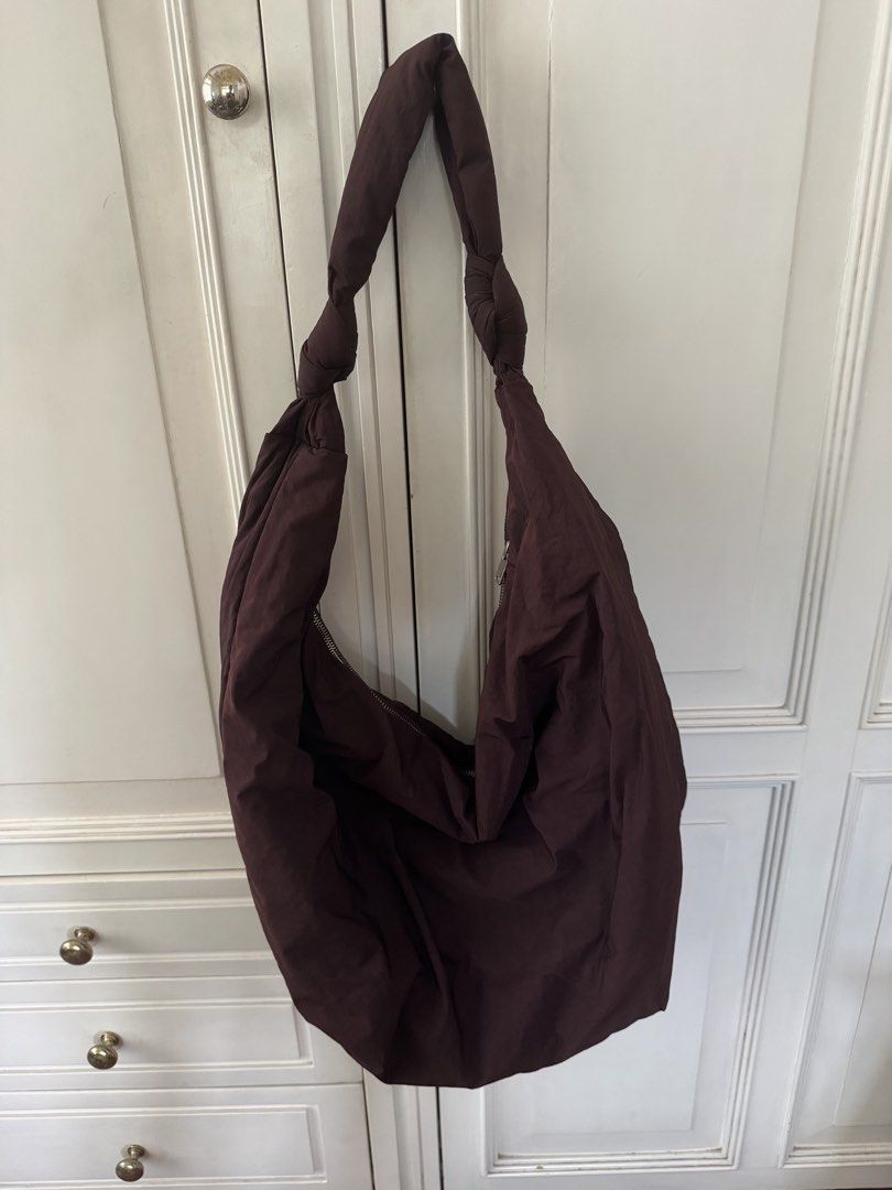COS Quilted Oversized Hobo Bag (Category: Shoulder Bags) located in Manila. Submitted by filibaby (Listing ID 1467058738, Image 1). Description: - Brand: COS - Style: Oversized quilted shoulder bag / slouchy hobo - Color: burgundy undertones - Material: Soft, padded fabric - Details: Knotted strap detail and secure top zip closure - Storage: Spacious main compartment with an interior zipped pocket for small items Hardly used. No visible flaws.