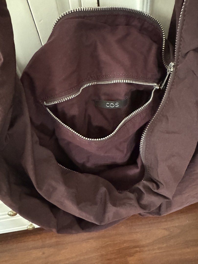 COS Quilted Oversized Hobo Bag (Category: Shoulder Bags) located in Manila. Submitted by filibaby (Listing ID 1467058738, Image 2). Description: - Brand: COS - Style: Oversized quilted shoulder bag / slouchy hobo - Color: burgundy undertones - Material: Soft, padded fabric - Details: Knotted strap detail and secure top zip closure - Storage: Spacious main compartment with an interior zipped pocket for small items Hardly used. No visible flaws.