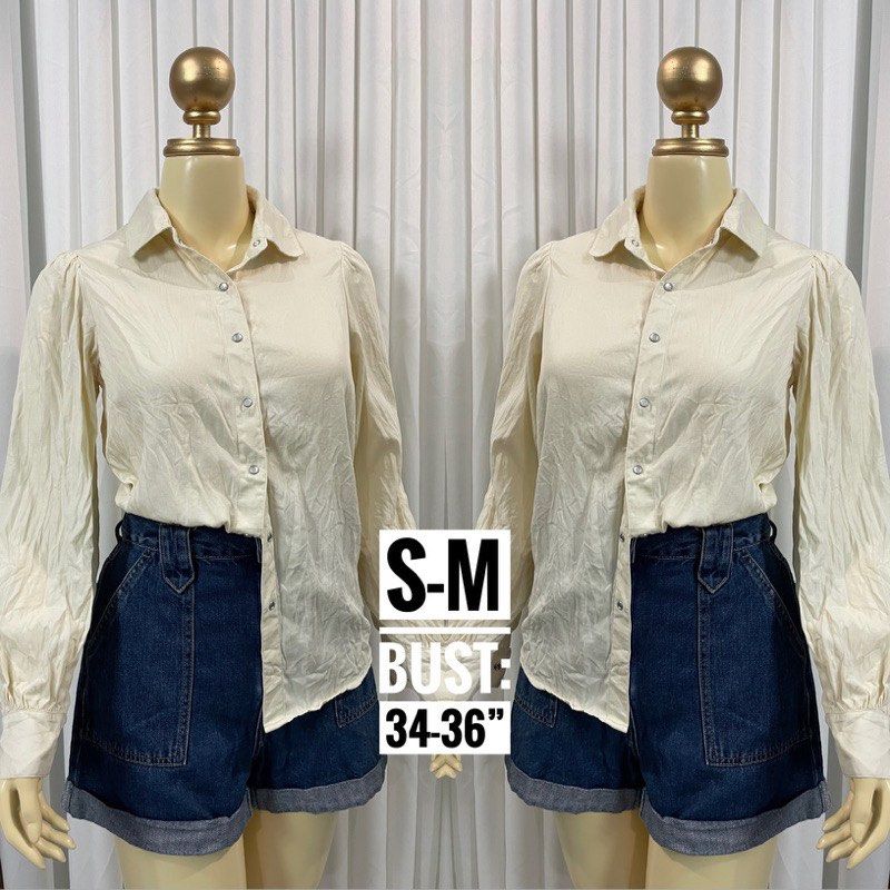 Cream Button-Up Long Sleeve Shirt (Category: Longsleeves) located in Manila. Submitted by escherichiaa (Listing ID 1467137278, Image 1). Description: - Brand: Peacebird - Color: Cream / Neutral - Style: Collar neck, snap button front, puff shoulders with gathered cuffs - Size & Fit: Fits Small to Medium (Best for 34"-36" bust) - Condition: Clean fabric, easy to style with denim shorts or skirts.