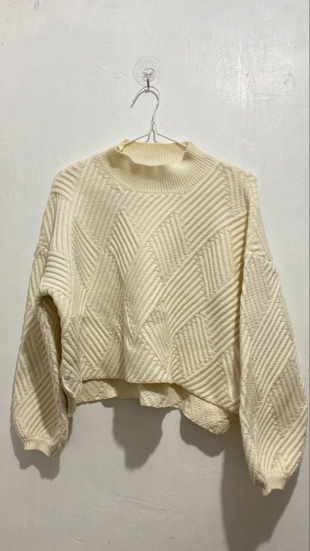 Cream Geometric Pattern Mock Neck Knit Sweater (Category: Longsleeves) located in Ozamiz City. Submitted by icadls (Listing ID 1467123472, Image 3). Description: - Color: Cream with a stylish geometric diagonal pattern - Fit: Relaxed fit with dropped shoulders and cropped length - Details: Ribbed mock neck collar and cuffs, soft textured knit fabric - Versatility: Great layering piece for cooler weather, perfect with high-waisted jeans or skirts.