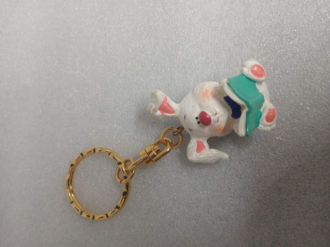 Cute White Rabbit Reading Book Metal Keychain Gold Ring (Category: Charms) located in Pila. Submitted by Yela.ph_1 (Listing ID 1467011696, Image 1). Description: - Adorable white rabbit design holding a green book - Premium gold-toned hardware with a textured split ring and swivel clasp - Hand-painted details including pink ears, cheeks, and nose - Versatile accessory, perfect for keys or bags.