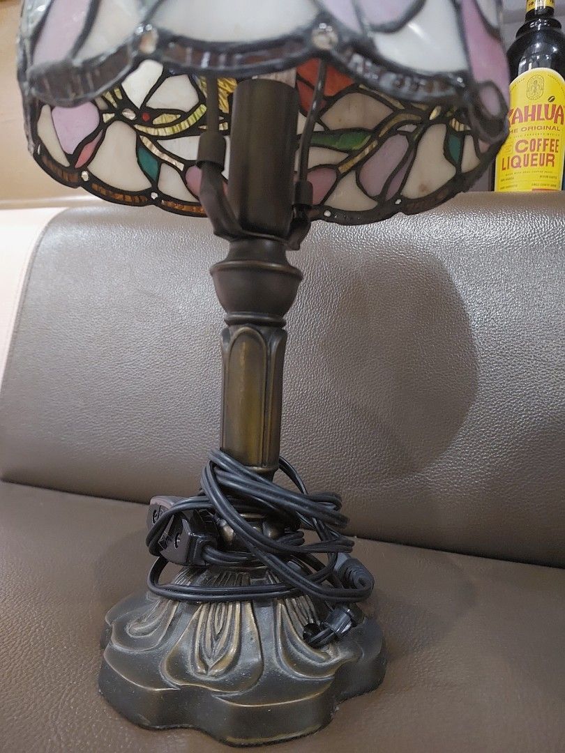 Dale Tyffany Lane Table Lamp (Category: Lighting) located in Bulacan. Submitted by hnbfinds (Listing ID 1466980083, Image 2). Description: This is a vintage-style Tiffany mini stained glass table lamp featuring a floral and leaf pattern with pink, purple, and green glass panels on a dark bronze-finish base (such as the Dale Tiffany Lane or L&L WMC Tiffa-Mini design). Ask a follow-up Finding beauty in the details. ✨ Swipe through to turn on the ul