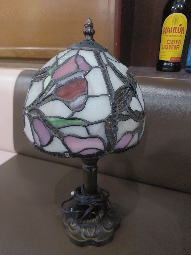 Dale Tyffany Lane Table Lamp (Category: Lighting) located in Bulacan. Submitted by hnbfinds (Listing ID 1466980083, Image 1). Description: This is a vintage-style Tiffany mini stained glass table lamp featuring a floral and leaf pattern with pink, purple, and green glass panels on a dark bronze-finish base (such as the Dale Tiffany Lane or L&L WMC Tiffa-Mini design). Ask a follow-up Finding beauty in the details. ✨ Swipe through to turn on the ul
