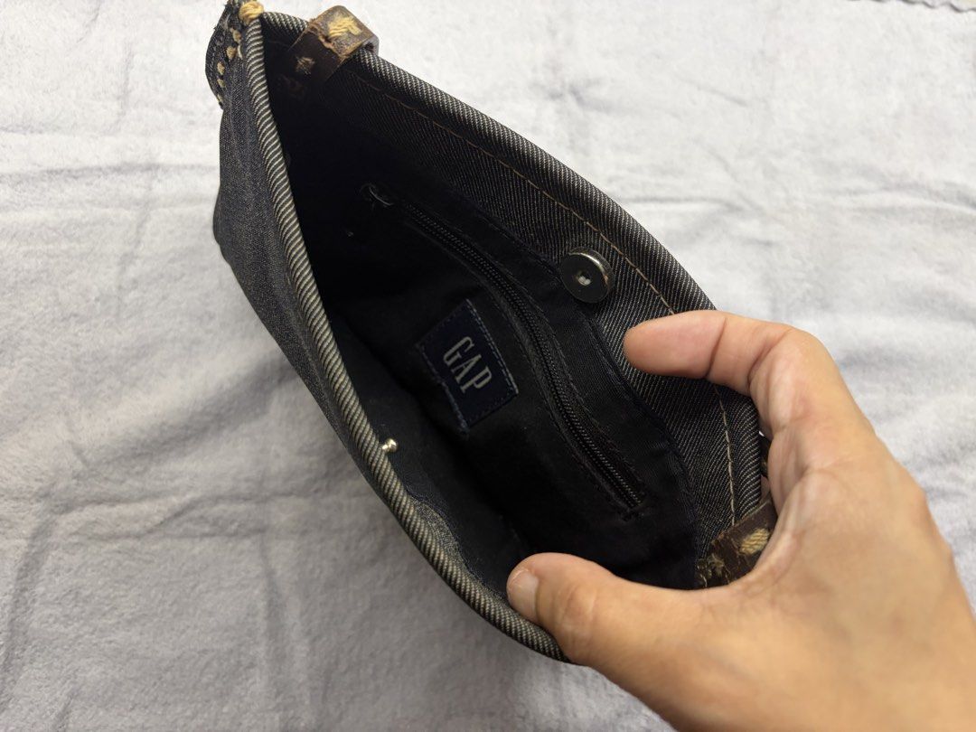 GAP denim shoulder bag with contrast stitching (Category: Purses & Pouches) located in Marikina City. Submitted by phelinky_finds (Listing ID 1467094539, Image 3). Description: 🛍️DESCRIPTION - Style: Small, compact dark denim shoulder bag - Details: Brown leather side strap with stylish contrast yellow stitching - Best For: Effortless everyday grab-and-go wear ✅ Condition: Slightly used, with minor signs of previous use. Please review the posted
