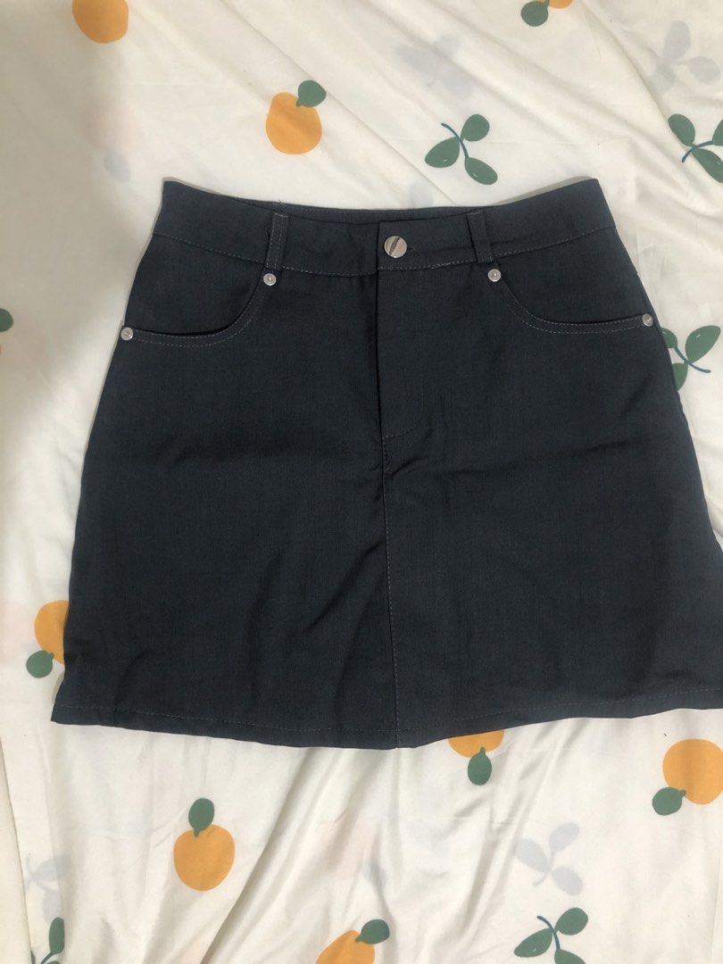 Dark Grey Soft Denim Skirt (Category: Skirts) located in Quezon City. Submitted by maggie.styles (Listing ID 1467130668, Image 1). Description: - Color: Dark grey - Style: Classic denim mini skirt - Features: Belt loops, metal button closure, front pockets with rivet details, and contrast stitching - Versatility: Easy to style with various tops and shoes.