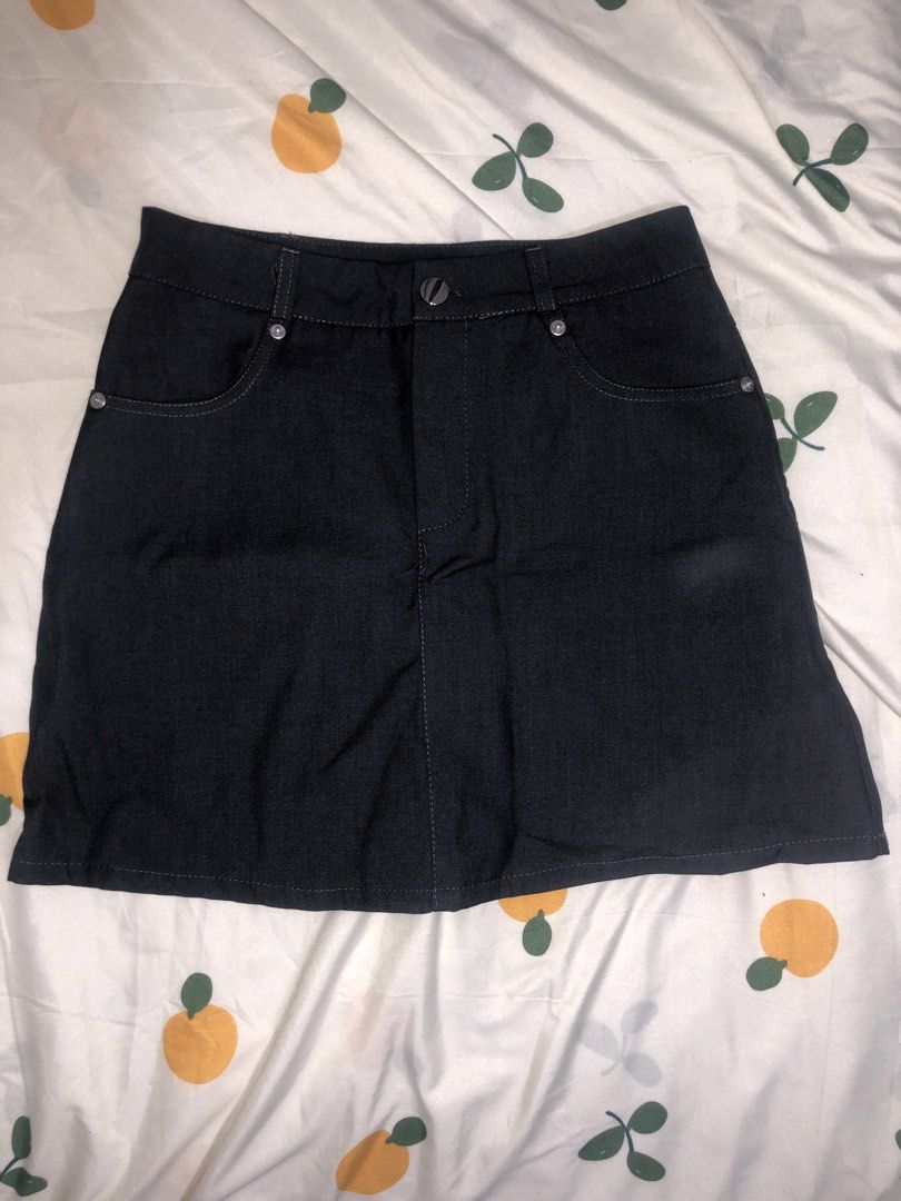 Dark Grey Soft Denim Skirt (Category: Skirts) located in Quezon City. Submitted by maggie.styles (Listing ID 1467130668, Image 2). Description: - Color: Dark grey - Style: Classic denim mini skirt - Features: Belt loops, metal button closure, front pockets with rivet details, and contrast stitching - Versatility: Easy to style with various tops and shoes.