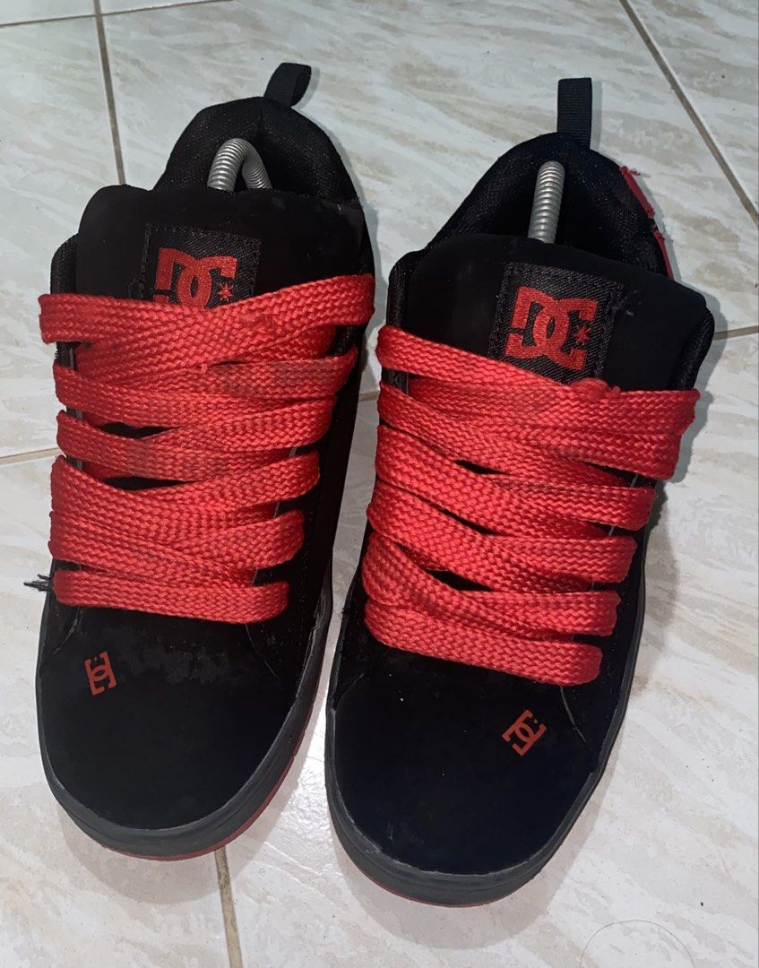 DC Shoes Black and Red Skate Shoes (Category: Sneakers) located in Baguio. Submitted by bruddafunk420 (Listing ID 1467106965, Image 2). Description: - Brand: DC Shoes - Colorway: Black and red with chunky red laces - Style: Classic puffy tongue design with bold red DC logos on the sides, heel, and toe - Soles: Black midsole with durable red rubber outsole - Condition: Shows visible wear on the suede upper and toe box - Durability: Still has plent