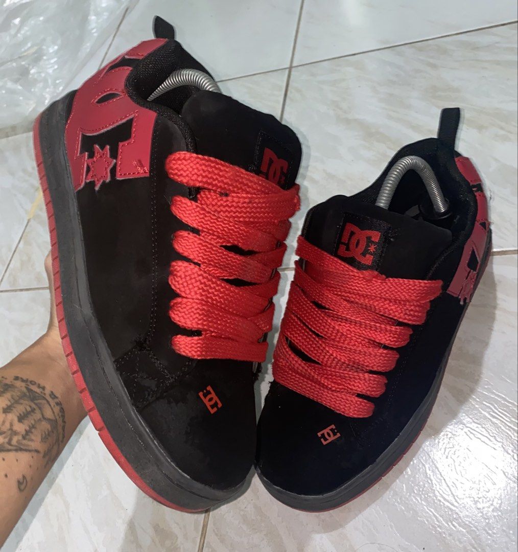 DC Shoes Black and Red Skate Shoes (Category: Sneakers) located in Baguio. Submitted by bruddafunk420 (Listing ID 1467106965, Image 1). Description: - Brand: DC Shoes - Colorway: Black and red with chunky red laces - Style: Classic puffy tongue design with bold red DC logos on the sides, heel, and toe - Soles: Black midsole with durable red rubber outsole - Condition: Shows visible wear on the suede upper and toe box - Durability: Still has plent