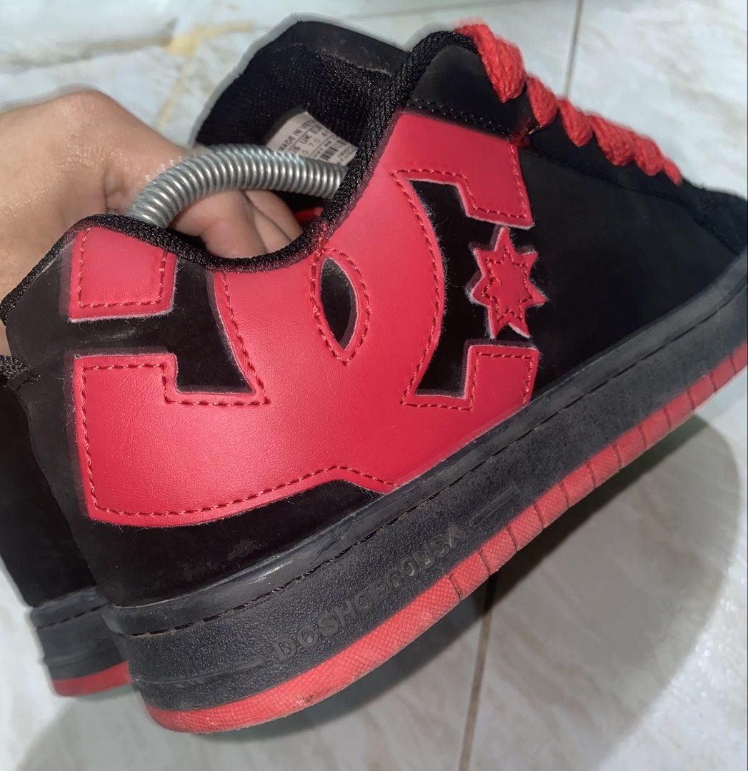 DC Shoes Black and Red Skate Shoes (Category: Sneakers) located in Baguio. Submitted by bruddafunk420 (Listing ID 1467106965, Image 3). Description: - Brand: DC Shoes - Colorway: Black and red with chunky red laces - Style: Classic puffy tongue design with bold red DC logos on the sides, heel, and toe - Soles: Black midsole with durable red rubber outsole - Condition: Shows visible wear on the suede upper and toe box - Durability: Still has plent