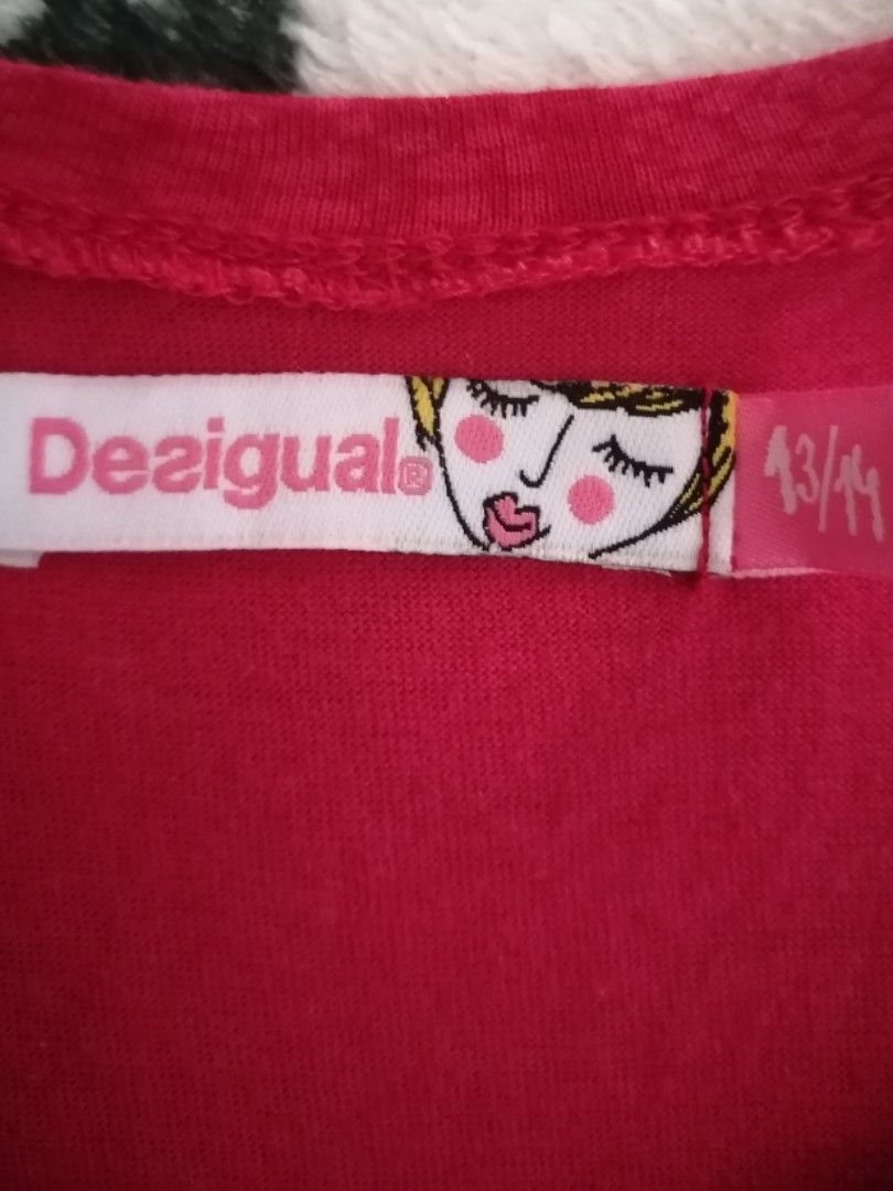 Desigual mini Dress Size (Category: Dresses) located in Davao. Submitted by blueberrycheesecake_03 (Listing ID 1467162768, Image 3). Description: - Brand: Desigual - Size: 13/14 years (can fit Xs adult) - Color: Vibrant pink, white, and multicolored - Design: Bold floral and feather skirt print with striped sleeves - Details: Round neckline, short sleeves, and embroidered front brand logo - Condition: In excellent condition - No issues.