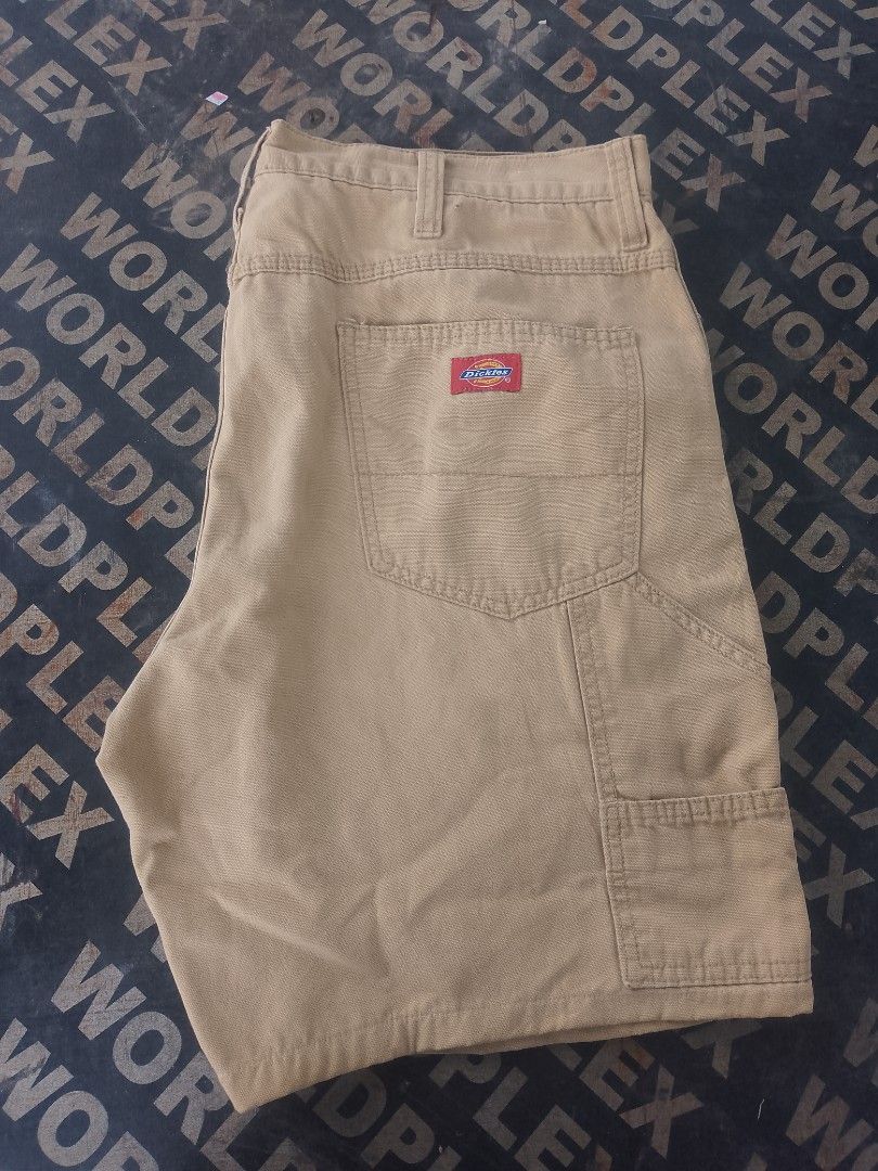 Dickies Cargo Utility Shorts Khaki Tan (Category: Shorts) located in Bacolod City. Submitted by carlo1019 (Listing ID 1467119560, Image 2). Description: - Brand: Dickies - Color: Khaki (Earth tone) - Material: Sturdy, heavy-duty cotton - Features: Multiple side and back pockets, heavy-duty belt loops - Detail: Iconic red Dickies logo patch on back right pocket - Style: Casual, workwear, daily wear.