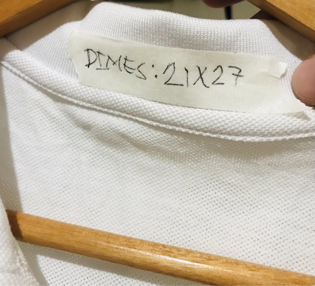 Dior Bee Embroidered White Polo Shirt (Category: Luxury Apparel) located in Rizal. Submitted by drthrifttwo (Listing ID 1466975973, Image 3). Description: - Brand: Dior - Item: Polo shirt with short sleeves and collar - Color: White - Size: Medium (21" chest x 27" length) - Material: Cotton and polyester blend - Design: Embroidered Dior logo and iconic Kaws bee patch on chest - Details: Two-button placket, made in China - Condition: Excellent / G