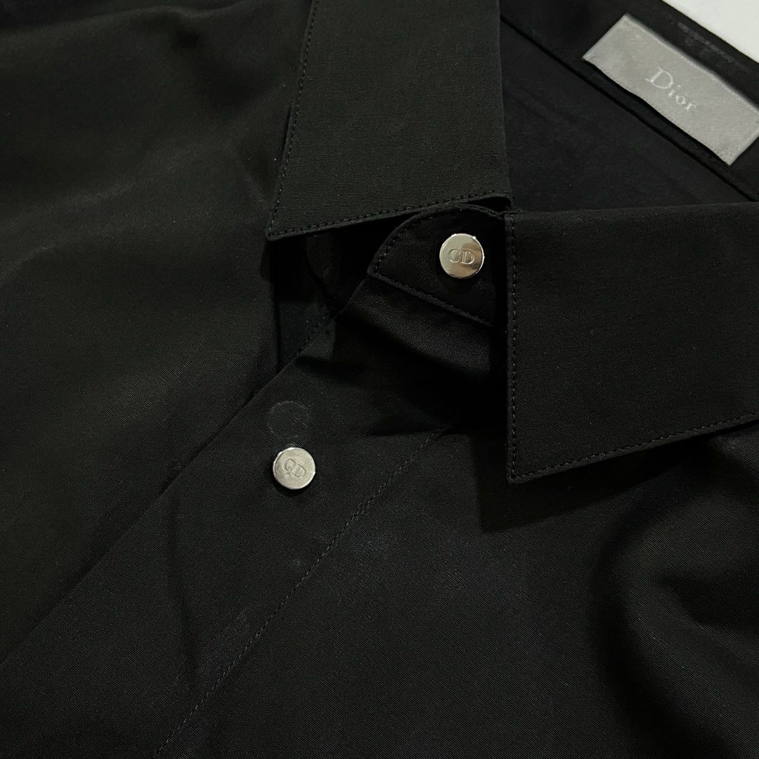 DIOR HOMME BUTTON UP SHIRT (Category: Luxury Apparel) located in Bacolod City. Submitted by the.finest (Listing ID 1467107031, Image 3). Description: Dior Homme CD Logo Metal Snap Button up Shirt Tag Size: 38 Width: 20 Length: 30-31 Condition: 9/10 7,000+shipping fee.