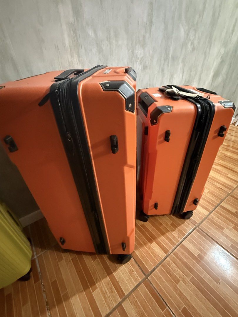 Compass Hardside Luggage Set Two Pieces (Category: Luggage) located in Manila. Submitted by abigailcaraan (Listing ID 1466995472, Image 3). Description: - Vibrant bright orange hardside luggage set (1 large suitcase + 1 matching cabin size case) - Rugged molded shell design with reinforced corners for extra durability - Smooth-rolling spinner wheels on both pieces for effortless mobility - Sturdy black grab handles and protective side feet - Secu