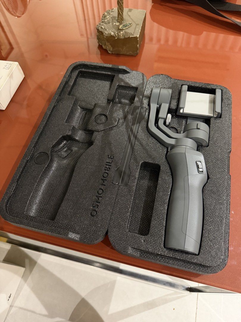 DJI Osmo Mobile 2 with Base (Category: Gimbals & Stabilizers ) located in Quezon City. Submitted by kyleddude007 (Listing ID 1467113878, Image 3). Description: - Item: DJI Osmo Mobile 2 Handheld Smartphone Stabilizer - Color: Gray - Condition: Refurbished unit (marked on packaging), fully tested and working - Inclusions: Original box and separate Osmo Mobile 2 base accessory - Features: Stands upright correctly on the base, perfect for smooth vid