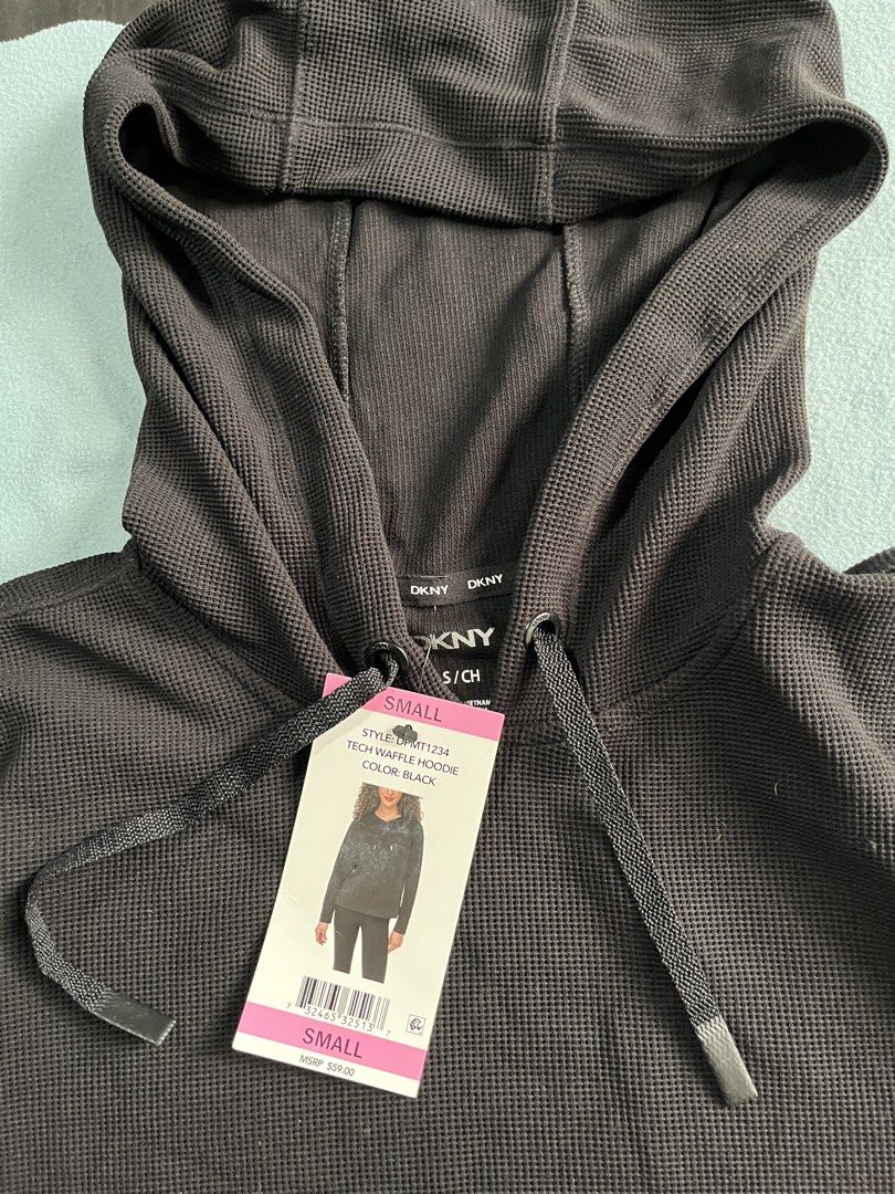 DKNY Tech Waffle Hoodie Black (Category: Coats, Jackets and Outerwear) located in Manila. Submitted by sunshineapril (Listing ID 1466978478, Image 2). Description: - Brand: DKNY - Item: Tech Waffle Hoodie - Color: Solid Black - Condition: Brand new with tags (BNWT), never worn - Details: Long sleeves, relaxed hood, matching drawstrings with metal tips, and subtle logo tag near hem - Original Retail Price: $59.00.