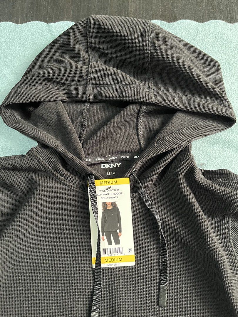DKNY Tech Waffle Hoodie Black Size Small (Category: Coats, Jackets and Outerwear) located in Manila. Submitted by sunshineapril (Listing ID 1466978598, Image 2). Description: - Brand: DKNY - Style: Tech Waffle Hoodie - Color: Solid Black - Condition: Brand new with original store tags, never worn - Features: Textured waffle knit fabric, adjustable drawstring hood, long sleeves, and subtle logo patch near the hem - Original Retail Price (MSRP): $5