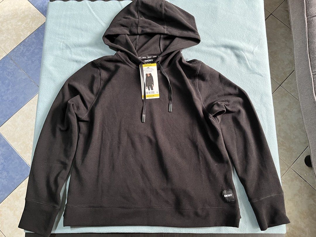 DKNY Tech Waffle Hoodie Black Size Small (Category: Coats, Jackets and Outerwear) located in Manila. Submitted by sunshineapril (Listing ID 1466978598, Image 1). Description: - Brand: DKNY - Style: Tech Waffle Hoodie - Color: Solid Black - Condition: Brand new with original store tags, never worn - Features: Textured waffle knit fabric, adjustable drawstring hood, long sleeves, and subtle logo patch near the hem - Original Retail Price (MSRP): $5
