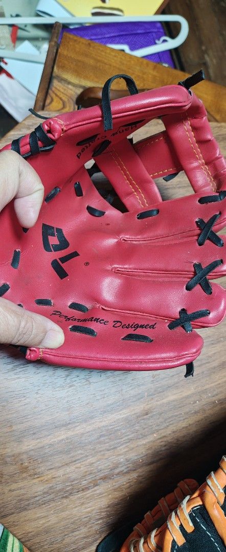 DL Sport Red Baseball Glove (Category: Racket and Ball Sports) located in Manila. Submitted by teng_d (Listing ID 1467164810, Image 2). Description: - Brand/Model: DL Sport baseball glove - Color & Style: Bright red with contrasting black lacing - Build: Hand-crafted, performance-designed palm lettering - Web Design: Traditional web with adjustable wrist strap - Orientation: Standard right-hand thrower setup - Condition: Ready for your next game 