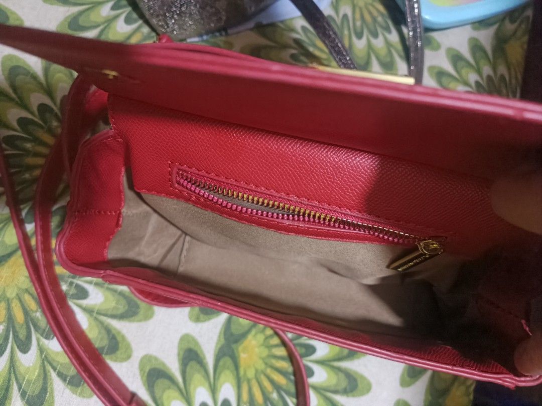 Dolce & Gabbana Red Leather Crossbody Bag (Category: Luxury Bags & Wallets) located in Cebu City. Submitted by elen30abalo (Listing ID 1467083729, Image 2). Description: - Color: Bright red with chic gold hardware accents - Material: Premium leather with a structured shape - Versatile: Includes a top handle and a matching detachable shoulder strap - Closure: Secure push-lock magnetic closure on the front flap - Interior: Fabric-lined with a conve