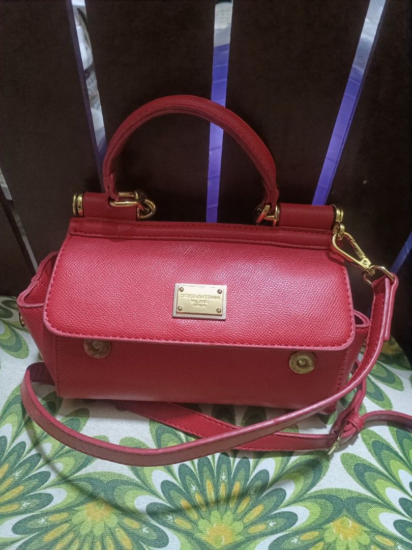 Dolce & Gabbana Red Leather Crossbody Bag (Category: Luxury Bags & Wallets) located in Cebu City. Submitted by elen30abalo (Listing ID 1467083729, Image 1). Description: - Color: Bright red with chic gold hardware accents - Material: Premium leather with a structured shape - Versatile: Includes a top handle and a matching detachable shoulder strap - Closure: Secure push-lock magnetic closure on the front flap - Interior: Fabric-lined with a conve