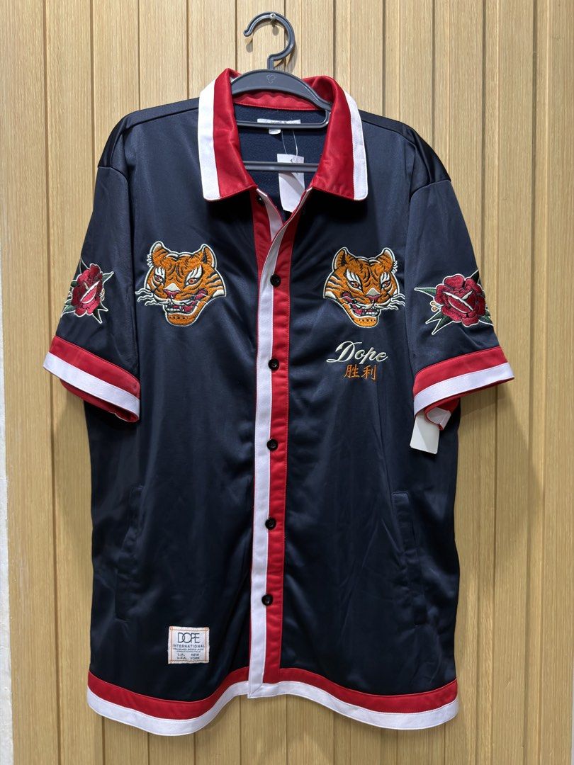 DOPE Mens Botton Down Polo XL (Category: Tshirts & Polo Shirts ) located in Bacoor. Submitted by preloved_with_love_ (Listing ID 1467155597, Image 1). Description: Dimensions: W 24in L 32in - Brand new with original store tags attached - Color: Navy blue with striking red and white trim - Design: Detailed tiger head and rose embroideries on chest and sleeves - Branding: Embroidered Dope lettering and Chinese characters with front patch branding -